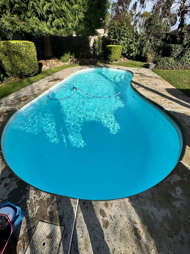 How to vacuum a pool manually using a vacuum head and hose