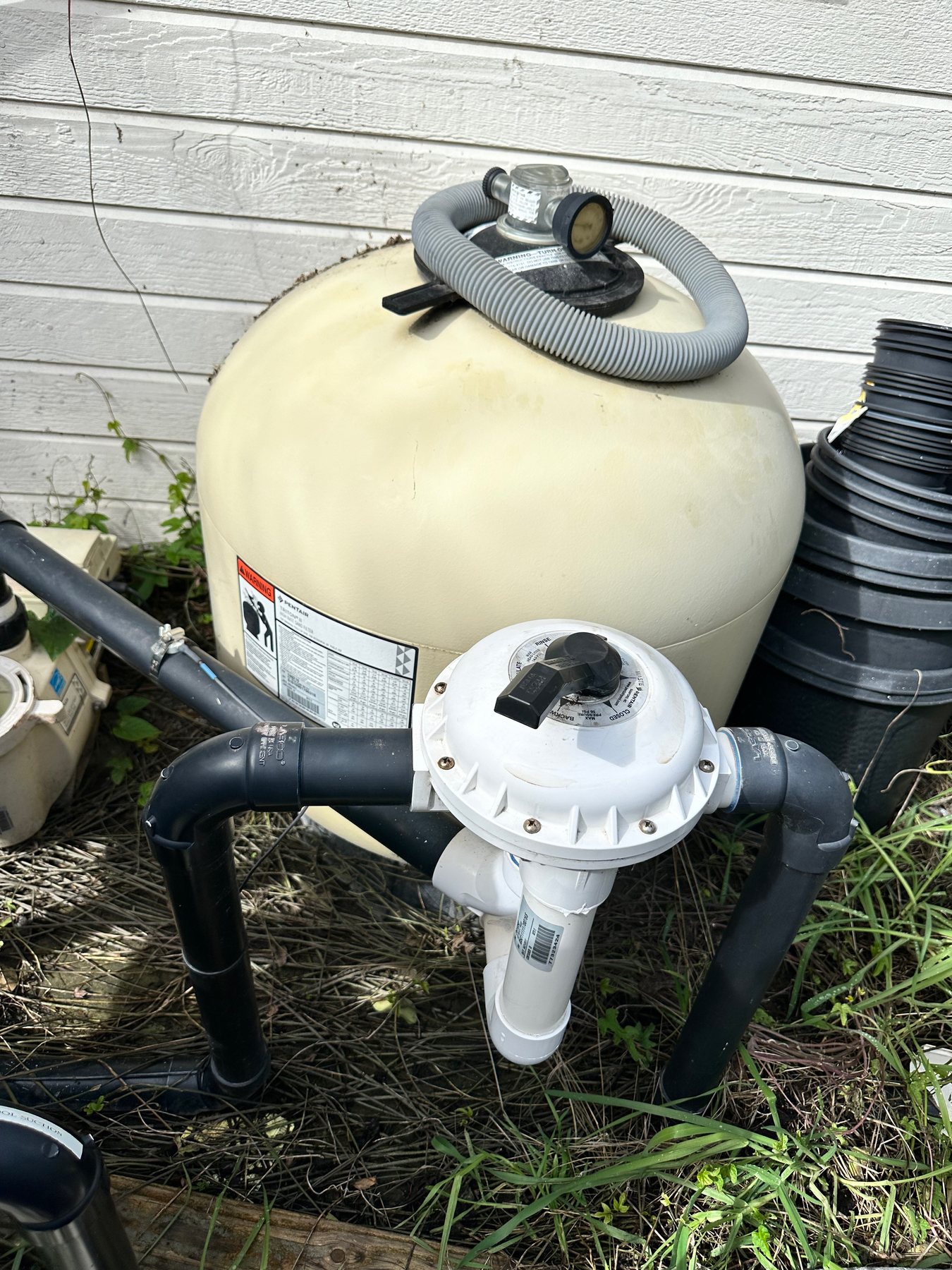 Sand filter and multiport valve on a residential pool equipment pad