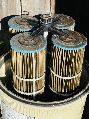 Heavily fouled pool filter cartridges before cleaning