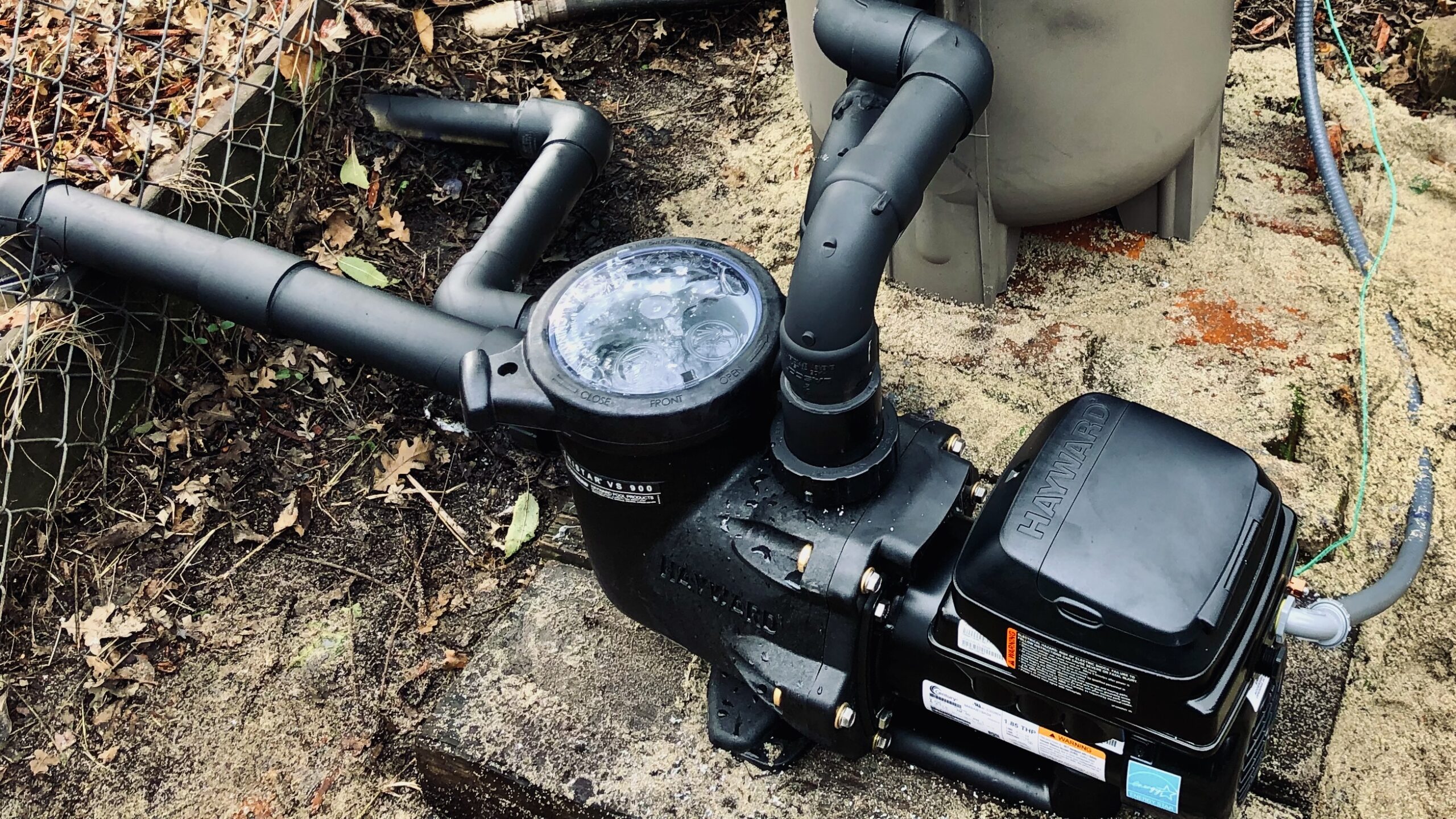 Variable-speed pool pump and plumbing at the equipment pad.