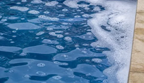 Foam collecting on the surface of a swimming pool